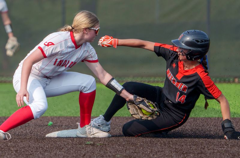 Brimfield/Elmwood’s Kendyl Binder, left, tags Beecher baserunner Liliana Irwin in the first inning of the Class 2A softball supersectional Monday, June 2 at Eastside Centre in East Peoria. The Bobcats defeated the Indians 4-3 in ten innings.