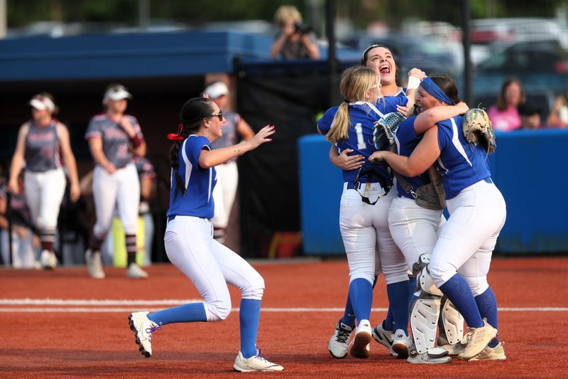 The Auburn/Lutheran softball team celebrates a 2-0 victory over Tolono Unity at the Millikin University Supersectional in Decatur on Monday, June 2, 2025.