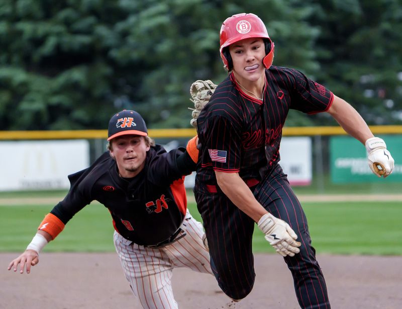 Washington's Gavin Lawrence puts a diving tag on Benet Academy's Merrick Sullivan on a rundown between first and second base in the sixth inning of the Class 3A baseball supersectional Monday, June 9, 2025 in Geneseo. The Panthers fell to the Redwings 6-3.