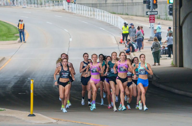 The elite women’s field of the Steamboat Classic USATF 4-Mile Championship heads up Eaton Street from the start on NE Washington on Saturday, June 14, 2025 in Downtown Peoria. Taylor Roe of Durham, North Carolina was the winner.