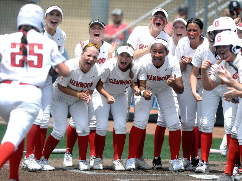 Glenwood's Sophia Feld's teammates greet her a home plate after she hit a home rung during the Class 3A state championship game against New Lenox Providence Catholic in softball Saturday, June 14, 2025.