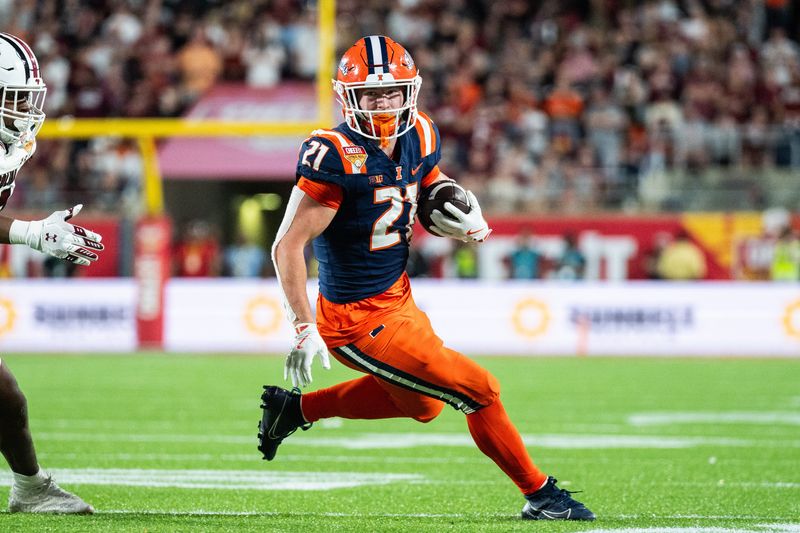 Dec 31, 2024; Orlando, FL, USA; Illinois Fighting Illini running back Aidan Laughery (21) runs the ball against South Carolina Gamecocks linebacker Debo Williams (0) in the fourth quarter at Camping World Stadium. Mandatory Credit: Jeremy Reper-Imagn Images