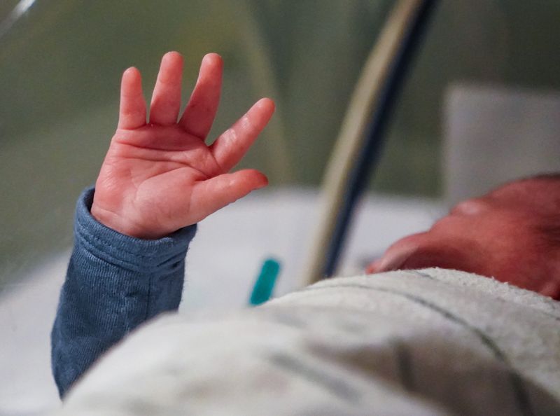 A newborn baby wriggles its little arm free from blankets at Ascension St. Vincent Women and Infants Hospital on Saturday, Jan. 18, 2025, in Indianapolis.