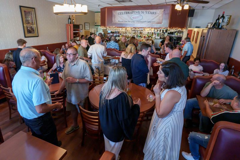 Patrons gather inside Rizzi’s Restaurant during a 30th anniversary celebration Tuesday, June 24, 2025 at the popular Italian eatery at 4613 N. Sheridan Road in Peoria.