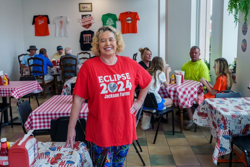 Otera Brinson stands in her new restaurant the Elmwood Junk Food Café in a former Subway site at 102 W. Main St. in Elmwood. The eatery specializes in generously loaded baked potatoes and a wide variety of gourmet hot dog creations.