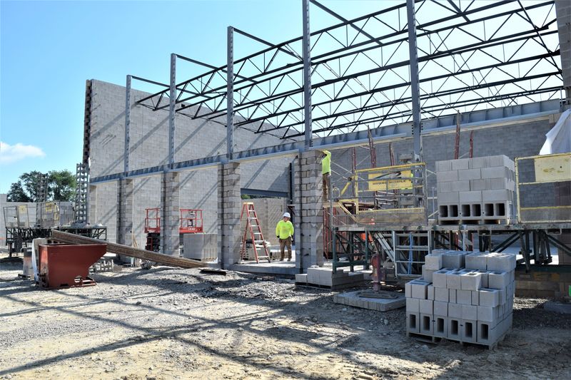 Construction workers are busy at the site of the new West Holmes Elementary School going up behind West Holmes High School.