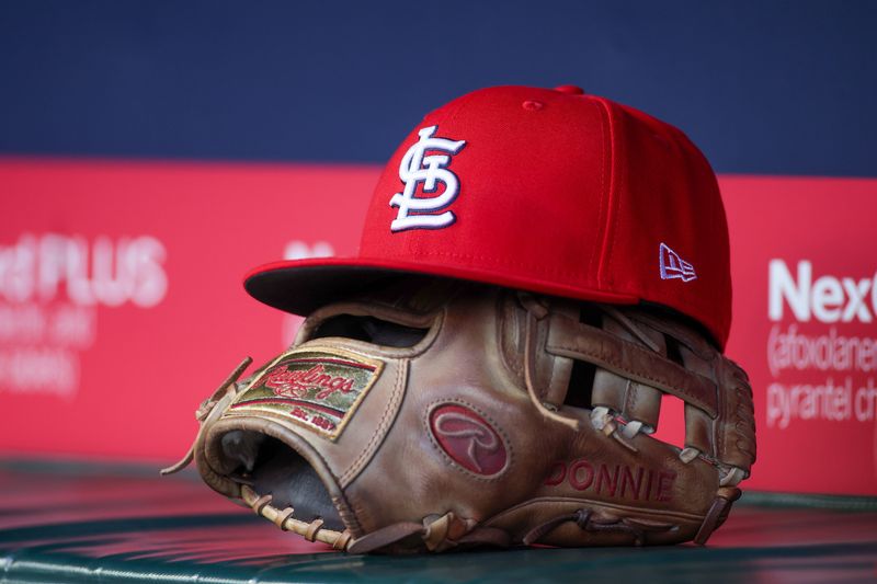 Apr 21, 2025; Atlanta, Georgia, USA; A St. Louis Cardinals hat and glove in the dugout against the Atlanta Braves in the first inning at Truist Park. Mandatory Credit: Brett Davis-Imagn Images