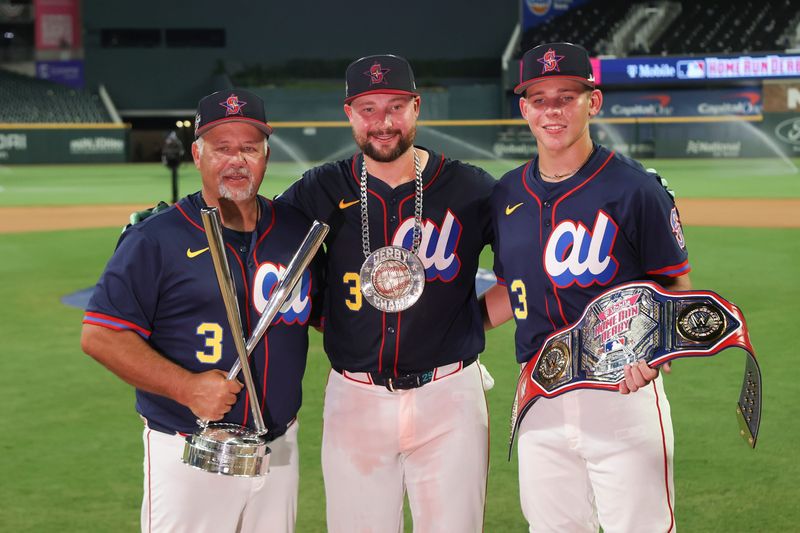 Cal Raleigh, center, poses for a photo with his dad Todd Raleigh and brother 'T' after winning the Home RunDerby.