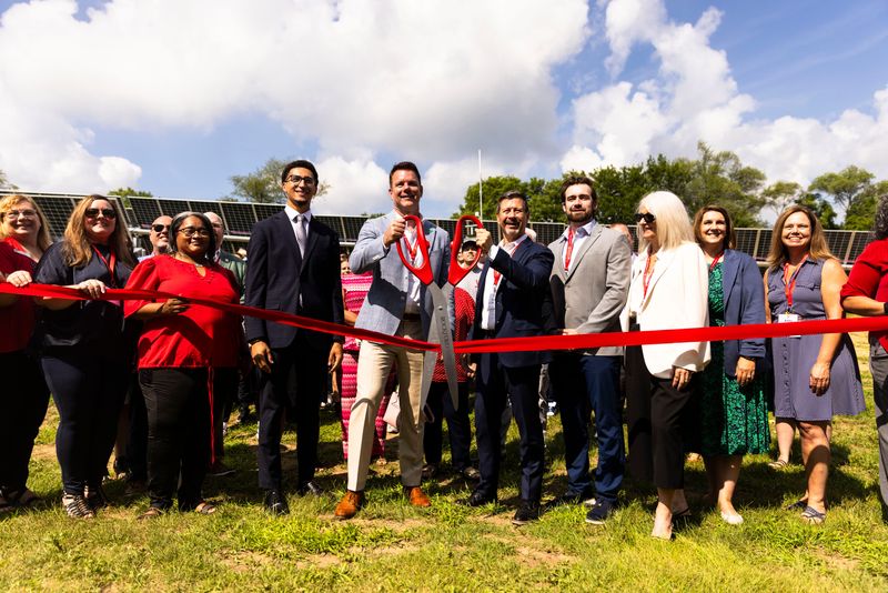 Roger Raley, vice president of Waldom Electronics, and Waldom Electronics CEO Don Akery, center, celebrate the opening of a new solar panel system Tuesday, July 15, 2025, at Waldom Electronics’ global headquarters in Rockford.
