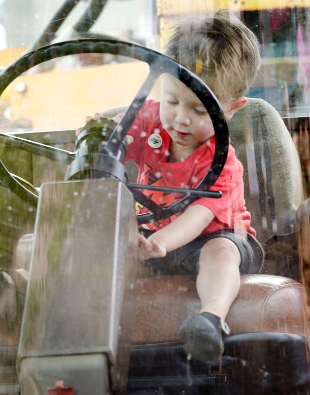 Caden Gadzinski, 2, of Manitowoc, checks over the controls of a bean picker machine during Touch the Trucks, sponsored by the Manitowoc Public Library, Wednesday, July 16, 2025, in Manitowoc, Wis.