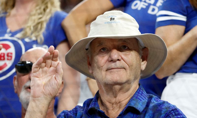Actor Bill Murray waves during the game between the Miami Marlins against the Chicago Cubs in 2023. Murray was part of a world record hot dog drop attempt July 22, 2025, in Joliet, Illinois. Murray is part of the ownership group of the Joliet Slammers baseball team.