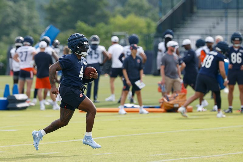 Jul 24, 2025; Lake Forest, IL, USA; Chicago Bears running back D'Andre Swift (4) runs with the ball during training camp at Halas Hall. Mandatory Credit: Kamil Krzaczynski-Imagn Images