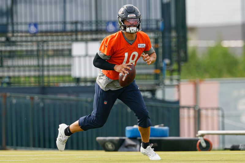 Jul 24, 2025; Lake Forest, IL, USA; Chicago Bears quarterback Caleb Williams (18) runs with the ball during training camp at Halas Hall. Mandatory Credit: Kamil Krzaczynski-Imagn Images