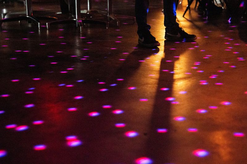 A disco ball reflects spots on light on the dance floor at Fly By Night during dance night on July 24, 2025 in Knoxville, Tennessee.