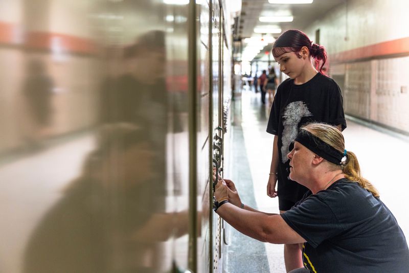 Incoming student Madison Laloggia and her grandma Kelli Castle enter the combination to a locker Aug. 12, 2025, during the West Middle School back to school open house in Rockford.