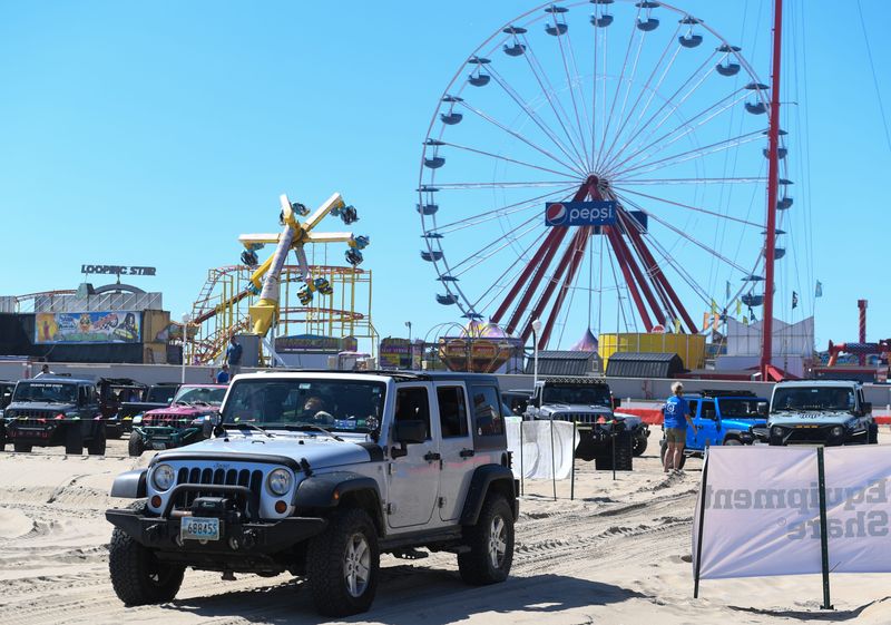 People drive offroad on the Jeep Fest sand course on the beach Friday, Aug. 22, 2025, in Ocean City, Maryland.
