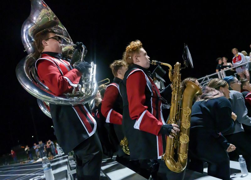 Members of the Metamora Marching Redbirds pump up the crowd in the second half of their high school football opener against Sterling on Friday, Aug. 29, 2025 at Metamora Township High School. The Redbirds routed the Golden Warriors 43-14.