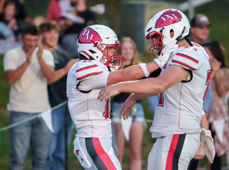 Dee-Mack’s Parker Eggenberger, left, and Vinnie Peek celebrate Eggenberger’s touchdown reception against Eureka in the first half of their high school football opener Friday, Aug. 29, 2025 at Eureka High School. The Chiefs routed the Hornets 38-8.