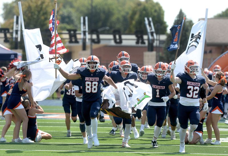 Rochester players run onto the field for their game against Gibson Southern Saturday, August 30, 2025.