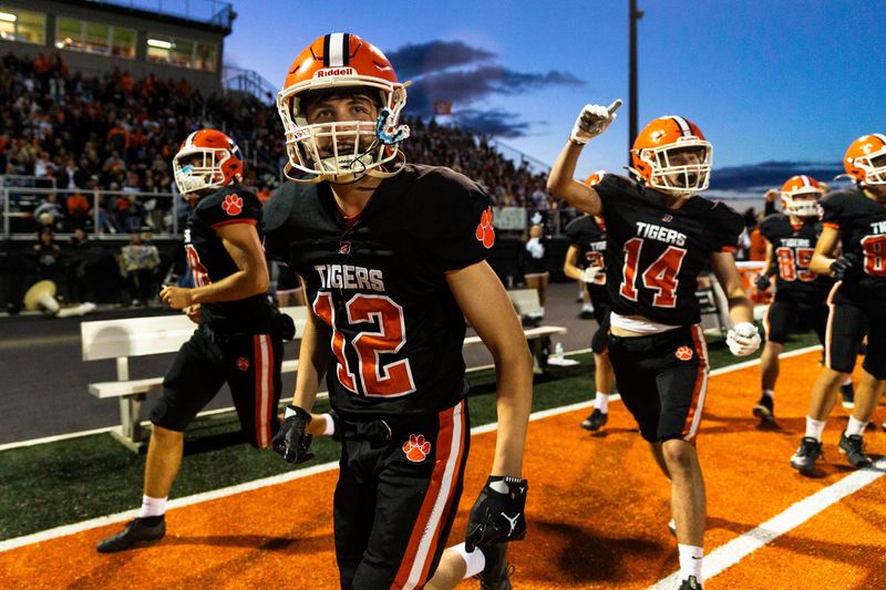 Byron’s Max Marchini (12) smiles and runs down the sidelines in celebration after scoring a touchdown on Sept. 5, 2025, at Byron High School.