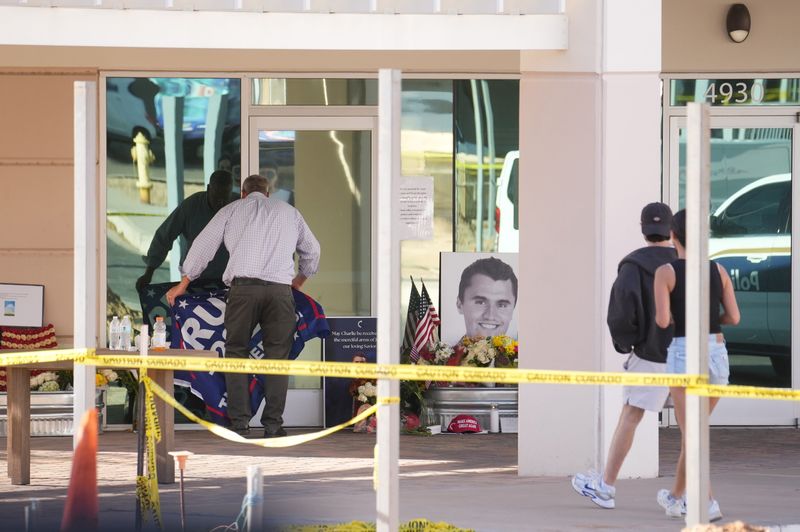 People congregate at Turning Point USA headquarters in Phoenix on Sept. 10, 2025, after news that the founder, Charlie Kirk, was shot and killed at a rally in Utah earlier that day.