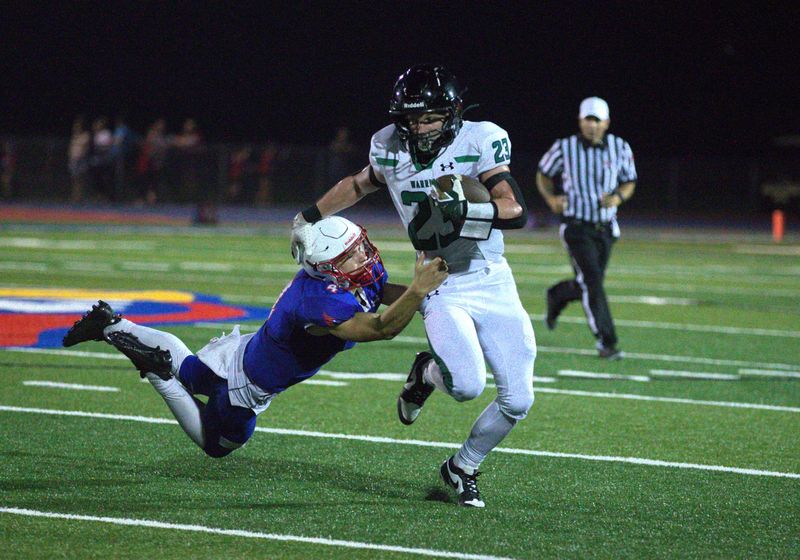 Athens senior running back Gage Honn breaks a tackle during a Sangamo Conference football game at Pleasant Plains on Friday, Sept. 12, 2025. Athens won 33-19.