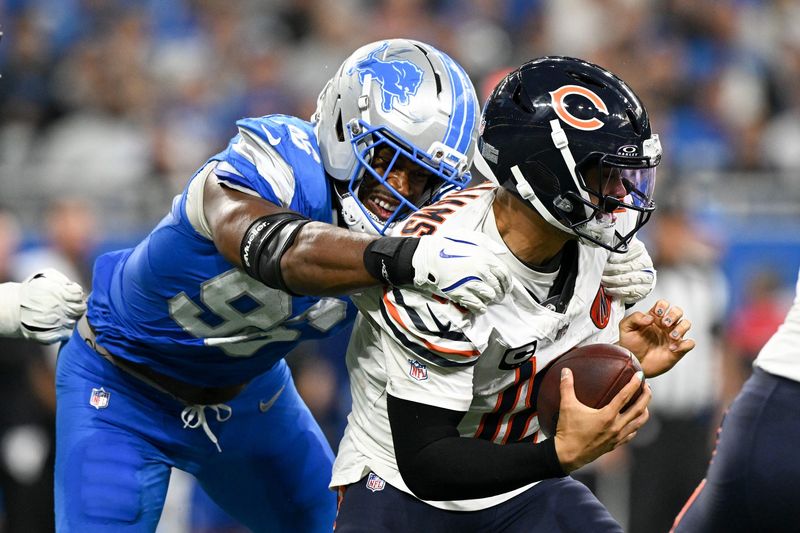 Sep 14, 2025; Detroit, Michigan, USA; Detroit Lions linebacker Al-Quadin Muhammad (96) sacks Chicago Bears quarterback Caleb Williams (18) during the third quarter of the game at Ford Field. Mandatory Credit: Lon Horwedel-Imagn Images