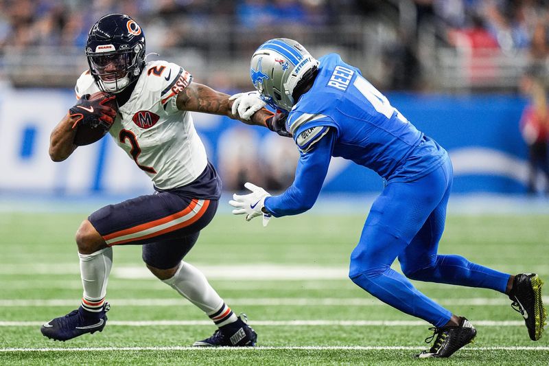 Detroit Lions cornerback D.J. Reed (4) tries to stop Chicago Bears wide receiver DJ Moore (2) during the first half at Ford Field in Detroit on Sunday, Sept. 14, 2025.