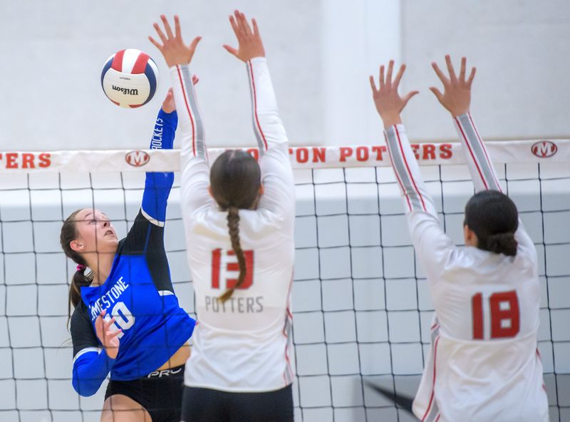 Limestone’s Bryn Williamson (10) spikes the ball against Morton’s Rebekah Stock (13) and Penelope Drake in the third set of their high school volleyball match Thursday, Sept. 18, 2025 in Morton. The Rockets took the match in three sets 25-15, 20-25, 25-21.