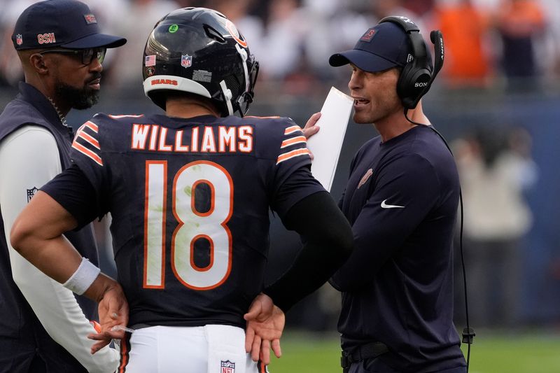 Sep 21, 2025; Chicago, Illinois, USA; Chicago Bears head coach Ben Johnson talks with quarterback Caleb Williams (18) against the Dallas Cowboys during the second half at Soldier Field. Mandatory Credit: David Banks-Imagn Images