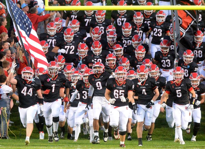 Glenwood players run onto the field to being the game against MacArthur Friday, Sept. 26, 2025.