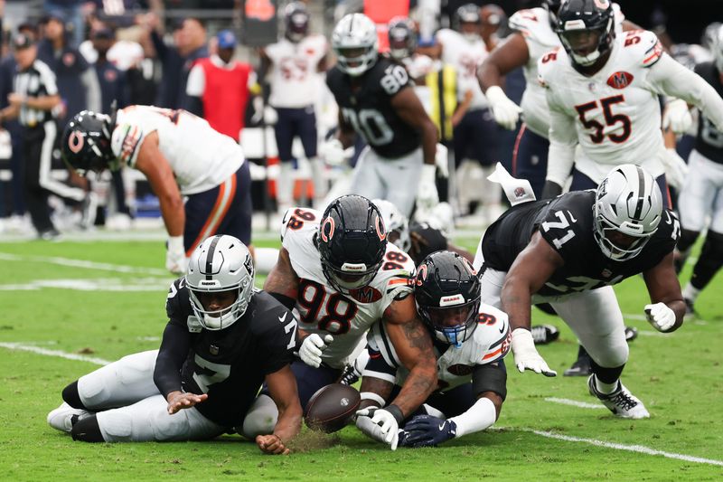 Sep 28, 2025; Paradise, Nevada, USA; Las Vegas Raiders quarterback Geno Smith (7), offensive tackle DJ Glaze (71), Chicago Bears defensive end Montez Sweat (98) and safety Jaquan Brisker (9) scramble for a loose ball after a sack in the first quarter at Allegiant Stadium. Mandatory Credit: Kiyoshi Mio-Imagn Images