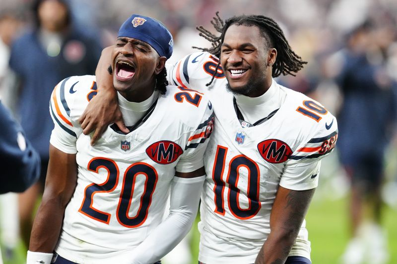 Sep 28, 2025; Paradise, Nevada, USA; Chicago Bears wide receiver Luther Burden III (10) and cornerback Zah Frazier (20) celebrates after the game against the Las Vegas Raiders at Allegiant Stadium. Mandatory Credit: Stephen R. Sylvanie-Imagn Images