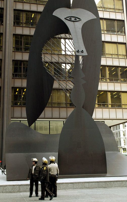 Cook county police officers wait in front of Chicago's famous Picasso sculpture for protesters to arrive for a November 8, 2002 demonstration against international free-trade policies being discussed at the Trans-Atlantic Business Dialogue summit.[ Several hundred of Chicago and Cook County police officers were on hand for the protest but only about 50 demonstrators showed up to protest. The three-day TABD summit is being hosted by Boeing CEO Phil Condit and other business leaders.]