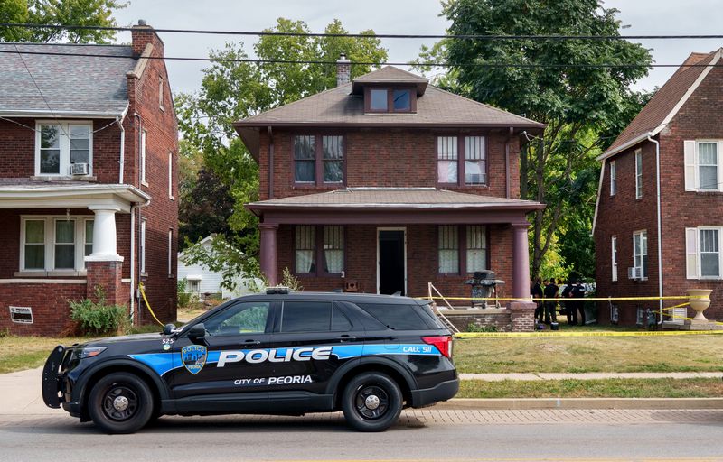 Peoria police officers remain at a house in the 2000 block of Sheridan Road where a 15-year-old boy was found dead after a report of gunshots fired Wednesday, Oct. 1, 2025 in Peoria.