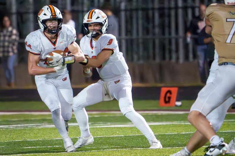 Washington quarterback Noah Garcia (9) hands off to running back Will Freeman as the Panthers battle Dunlap in the second half of their Week 7 high school football game Friday, Oct. 10, 2025 at Dunlap High School. The Panthers defeated the Eagles 23-15.