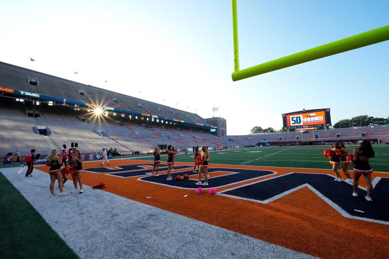 Illinois spirit squad members stand for photos in the endzone prior to the NCAA football game between the Illinois Fighting Illini and the Ohio State Buckeyes at Gies Memorial Stadium in Champaign on Oct. 11, 2025.