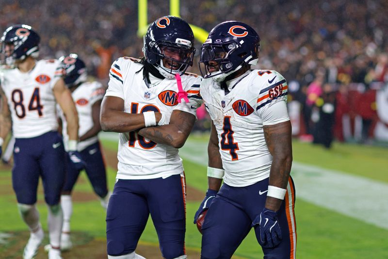 Oct 13, 2025; Landover, Maryland, USA; Chicago Bears running back D'Andre Swift (4) celebrates scoring a touchdown with Luther Burden III (10) during the fourth quarter against the Washington Commanders at Northwest Stadium. Mandatory Credit: Peter Casey-Imagn Images