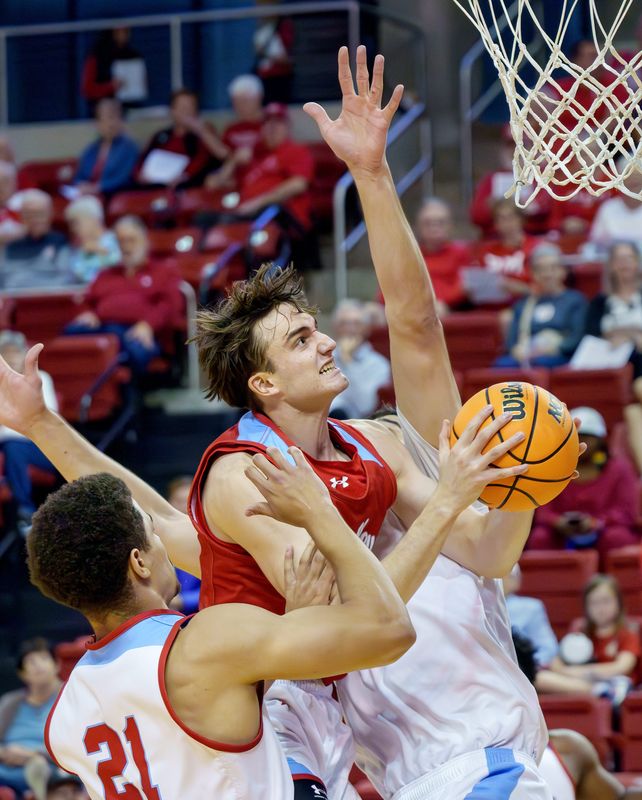 Bradley’s Timoty van der Knapp of the Red Team goes to the basket against the White Team’s A.J. Smith (21) and Ahmet Jonovic during the Red-White Showcase on Saturday, Oct. 18, 2025 at Renaissance Coliseum.