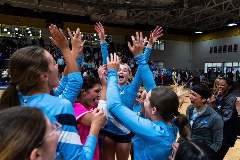 Guilford players celebrate winning the NIC-10 volleyball title against Hononegah on Oct. 21, 2025, at Hononegah High School.