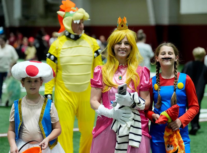Oct 27, 2025; Tuscaloosa, Alabama, USA; Jackie Harrison comes to the Halloween Extravaganza at the Hank Crisp Indoor Practice Facility with her daughters Scarlett and Savannah where children could interact with University of Alabama athletes.