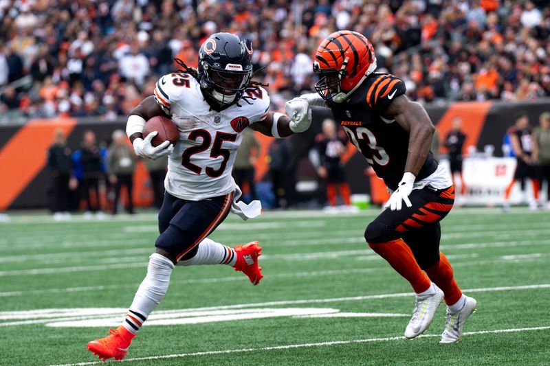 Chicago Bears running back Kyle Monangai (25) stiff arms Cincinnati Bengals cornerback Dax Hill (23) in the second quarter of the NFL football game between Chicago Bears and Cincinnati Bengals at Paycor Stadium in Cincinnati on Nov. 2, 2025.