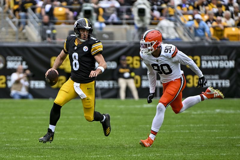 Oct 12, 2025; Pittsburgh, Pennsylvania, USA; Pittsburgh Steelers quarterback Aaron Rodgers (8) attempts to run the ball while Cleveland Browns defensive end Joe Tryon-Shoyinka (90) pursues during the second quarter at Acrisure Stadium. Mandatory Credit: Barry Reeger-Imagn Images