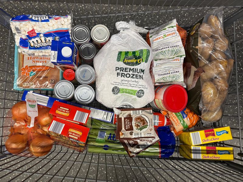 A shopping cart filled with items in Aldi's $40 Thanksgiving meal bundle.