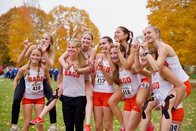 The Winnebago girls celebrate after winning the IHSA Class 1A girls cross country state championship on Nov. 8, 2025, in Peoria.