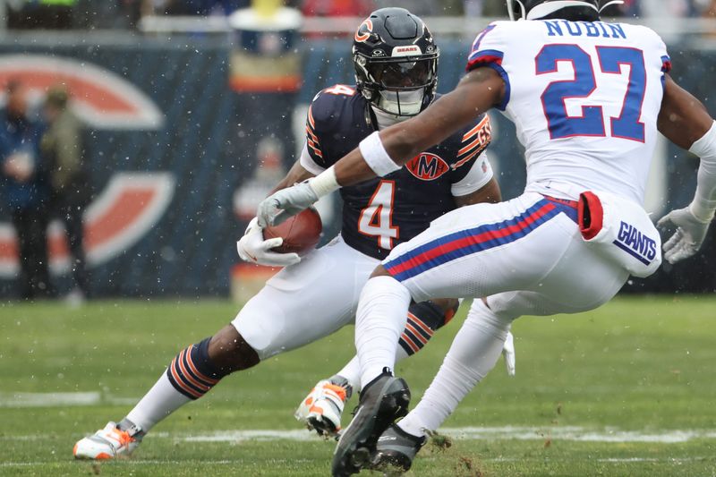 Nov 9, 2025; Chicago, Illinois, USA; Chicago Bears running back D'Andre Swift (4) rushes the ball against the New York Giants during the first half at Soldier Field. Mandatory Credit: Mike Dinovo-Imagn Images
