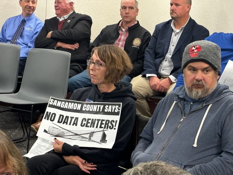Claire Heffron-McKinney of Springfield holds a sign in opposition to a proposed data center in Talkington Township just prior to the Sangamon County Board meeting on Nov. 10, 2025. The board will most likely take up a vote on the center in January.