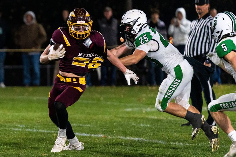 Stockton’s Carter Blair (26) gets pulled by Dwight defense during a quarterfinal game against Dwight on Nov. 15, 2025, at Stockton High School.