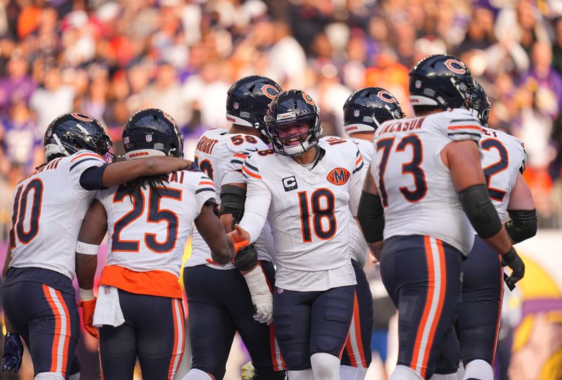 Nov 16, 2025; Minneapolis, Minnesota, USA; Chicago Bears running back Kyle Monangai (25) and quarterback Caleb Williams (18) celebrate a touchdown during the second quarter against the Minnesota Vikings at U.S. Bank Stadium. Mandatory Credit: Brad Rempel-Imagn Images