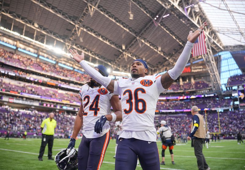 Nov 16, 2025; Minneapolis, Minnesota, USA; Chicago Bears defensive back Jonathan Owens (36) and cornerback Nick McCloud (24) react after defeating the Minnesota Vikings at U.S. Bank Stadium. Mandatory Credit: Brad Rempel-Imagn Images